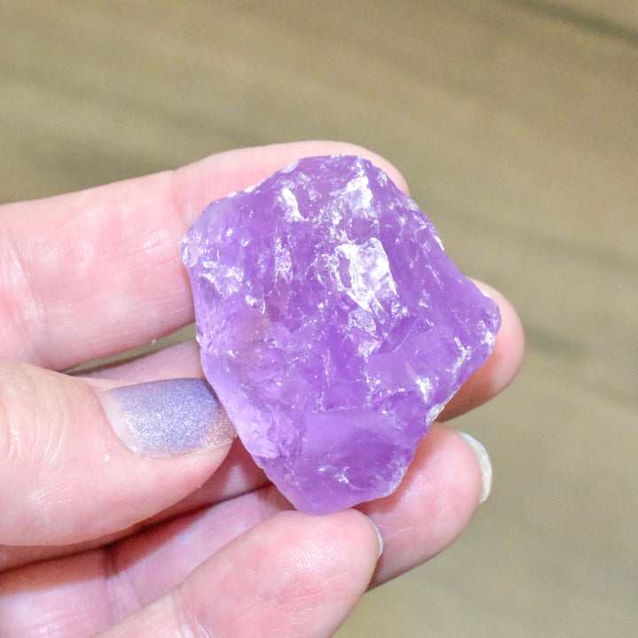Natural Brazilian amethyst rough stone crystal showing purple color and raw unpolished texture