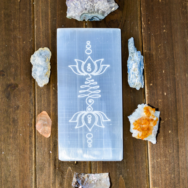 Large rectangular selenite charging plate with carved lotus flower and unalome Buddhist symbols