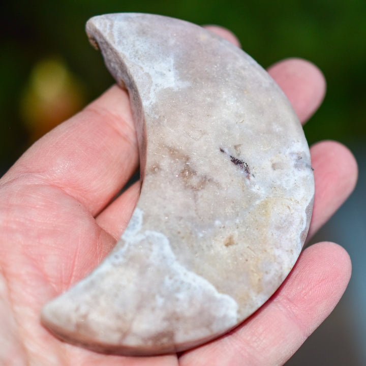 Handcrafted pink amethyst crescent moon stone from Brazil showing natural rose colored crystal formation