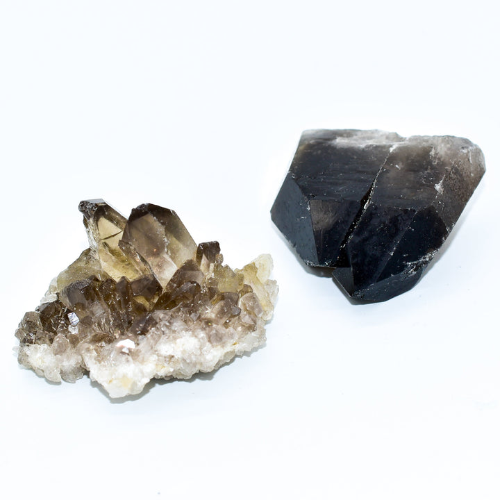 Grade A Brazilian smokey quartz crystal cluster with translucent gray points on white background