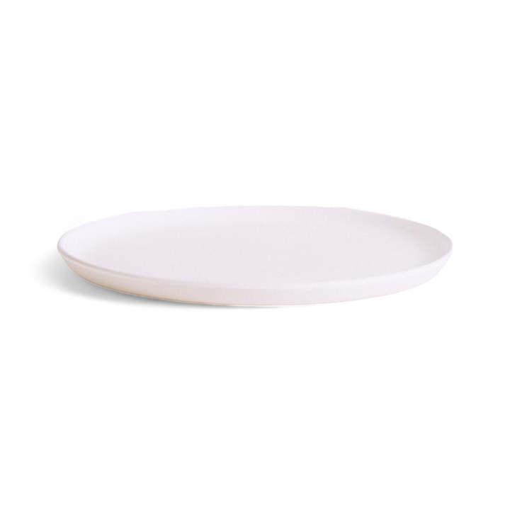 Set of four handmade Tunisian stoneware dinner plates in matte white finish on wooden surface
