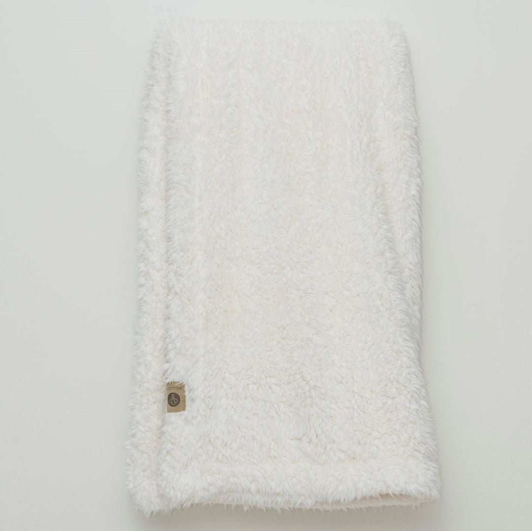 Angel Plush Blanket in Whisper White, showcasing its soft, luxurious texture ideal for nurseries and living rooms.