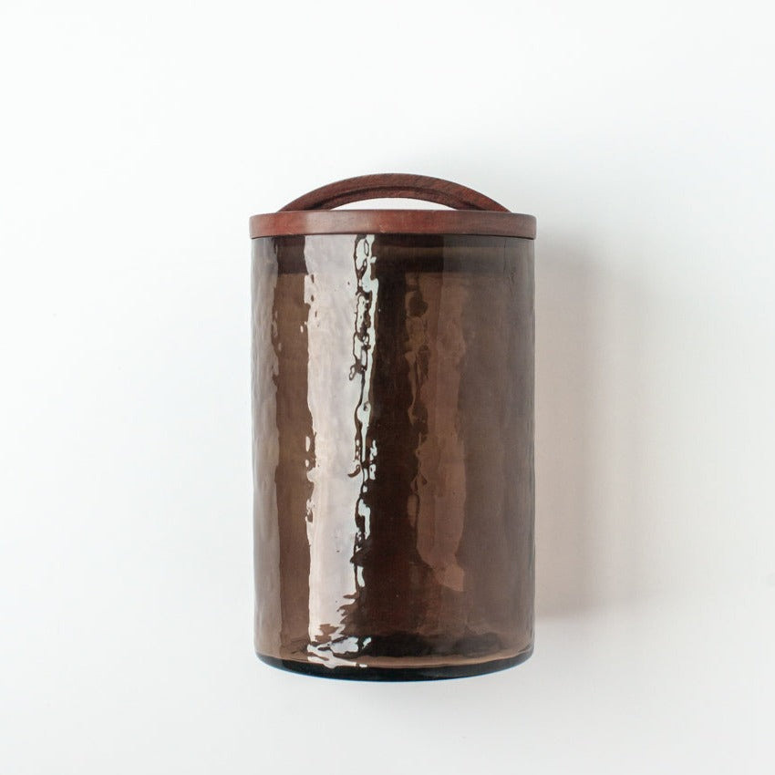 Large smoke glass canister with hand-carved wooden lid for airtight storage, ideal for kitchen or apothecary use.