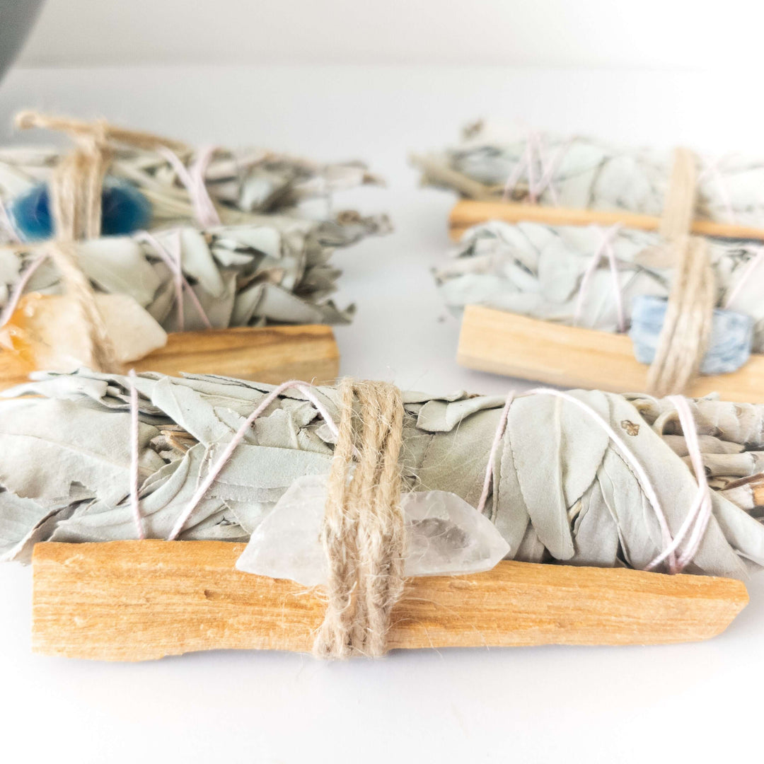 Palo Santo, crystal, and sage smudge bundle for spiritual cleansing and positive energy in the home.