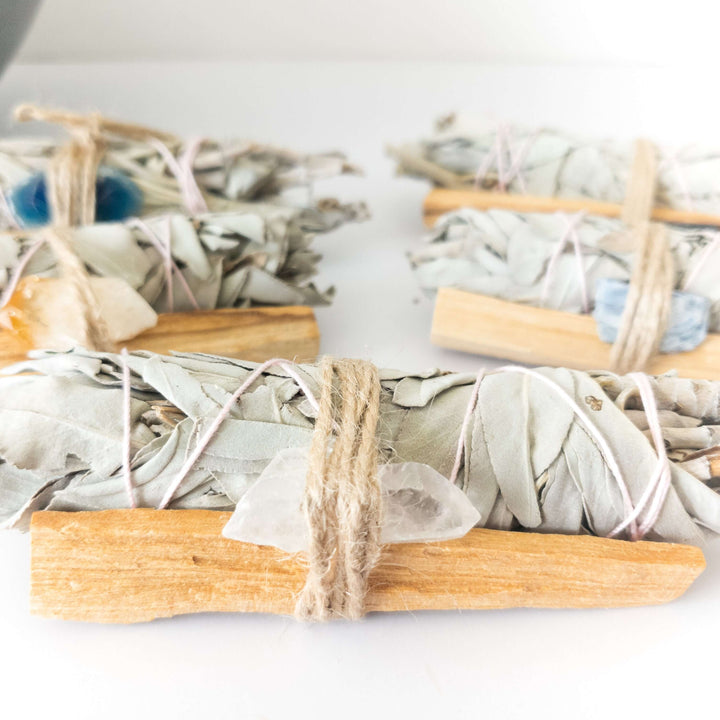 Palo Santo, crystal, and sage smudge bundle for spiritual cleansing and positive energy in the home.