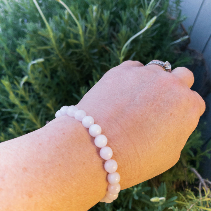 Natural semi-precious stone beaded bracelets stacked on wrist with mixed metals jewelry