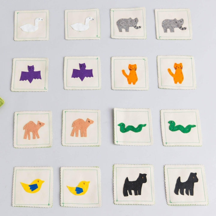 Handmade felt memory game with colorful land animal pairs in compact carrying case for educational play