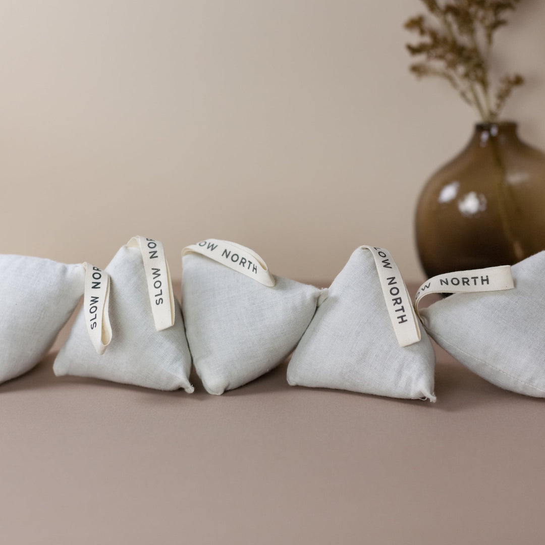 Cotton natural lavender sachets arranged in a row, ideal for freshening drawers, closets, or cars with calming aromatherapy benefits.