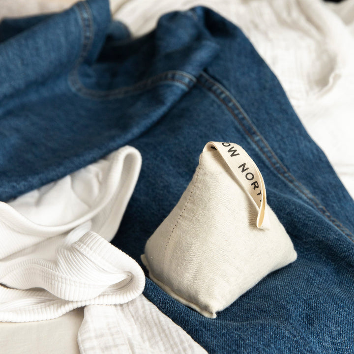 Natural cotton lavender sachet on denim and white clothes, ideal for drawers, closets, or cars to freshen and relax with aromatherapy.