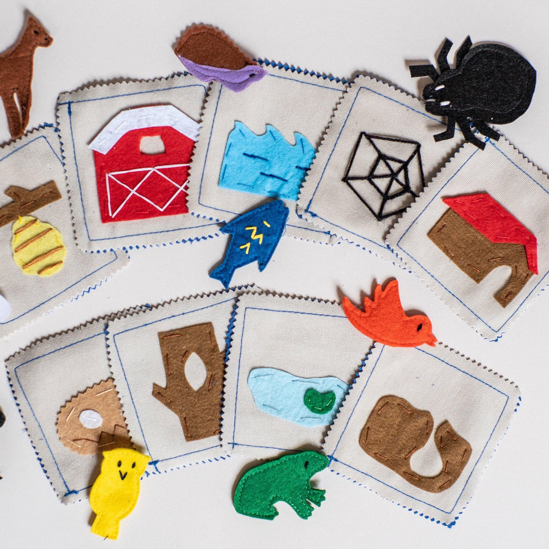 Handmade felt animal habitat matching game with carrying case showing 9 animals and habitat cards