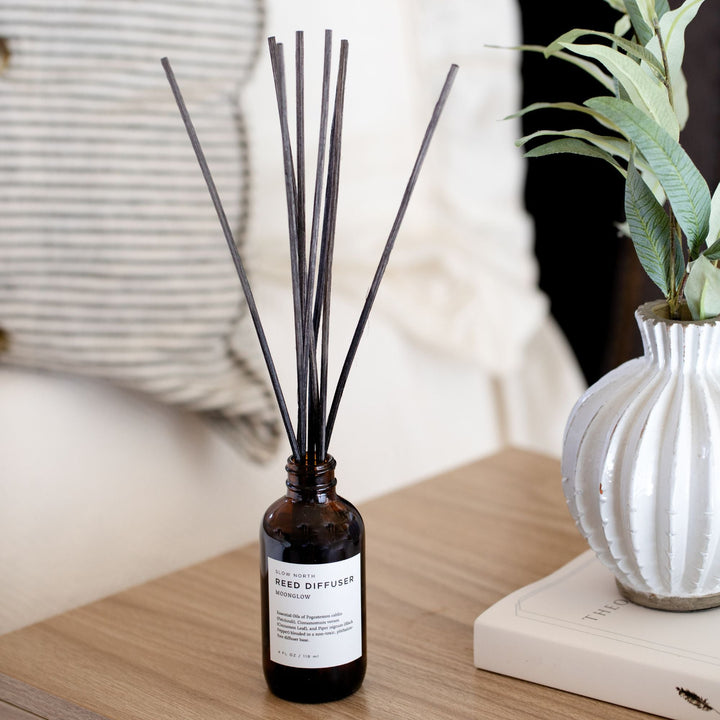 Moonglow reed diffuser with natural rattan reeds in elegant glass bottle, patchouli cinnamon scent for home aromatherapy