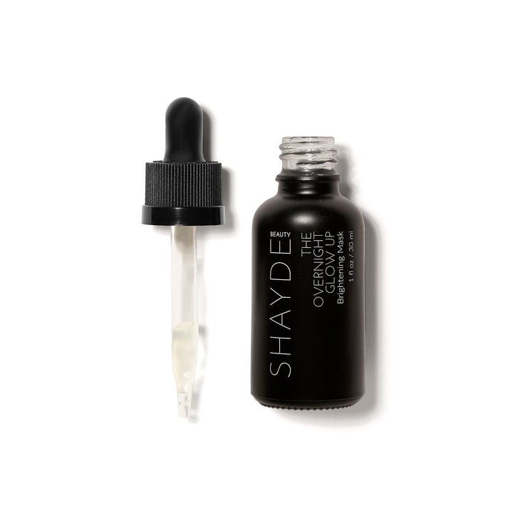 Open bottle of Shayde Overnight Glow Up Mask with dropper, reduces dark spots and acne marks, infused with Niacinamide and fruit extracts.