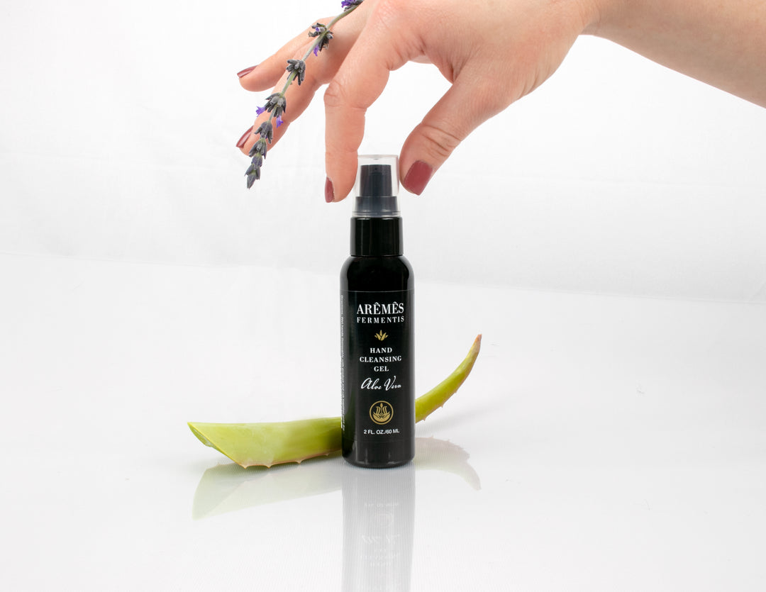 Aloe Vera Hand Cleansing Gel bottle with aloe leaf and lavender sprig, promoting hygiene and hydration with 62% alcohol, 2 oz size.