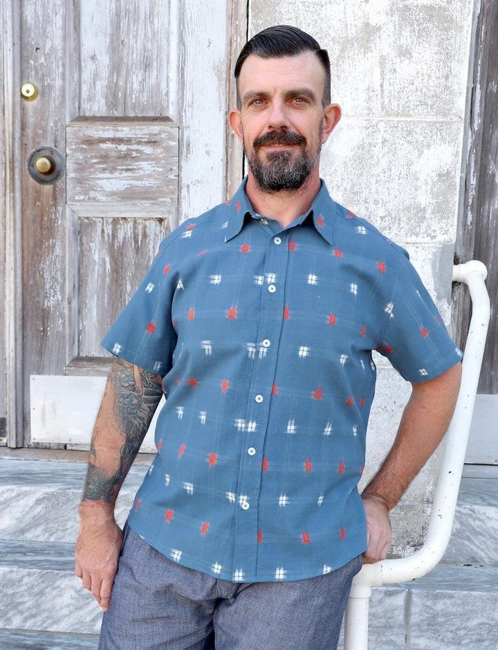 Blue ikat organic cotton button down shirt with orange and white accents handwoven by artisans