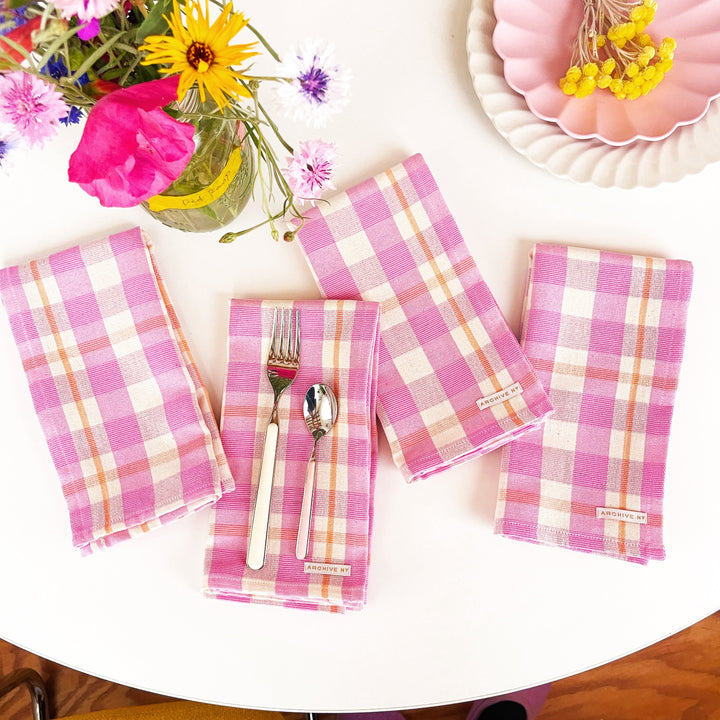 Handwoven plaid dinner napkin with bubblegum and peach stripes made by Guatemalan artisans