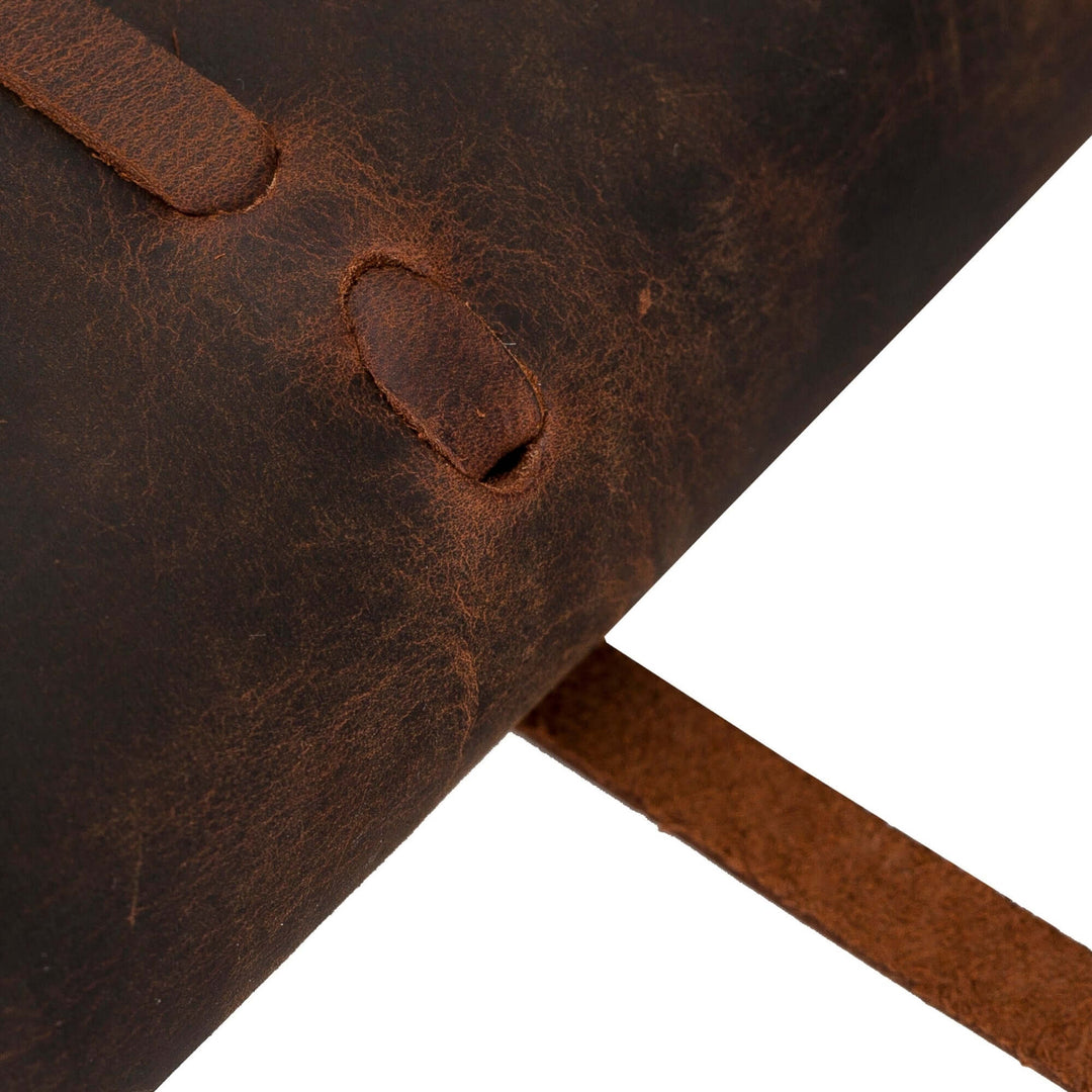 Close-up of TORONATA's Broomfield handcrafted leather journal cover with strap and aged leather texture.