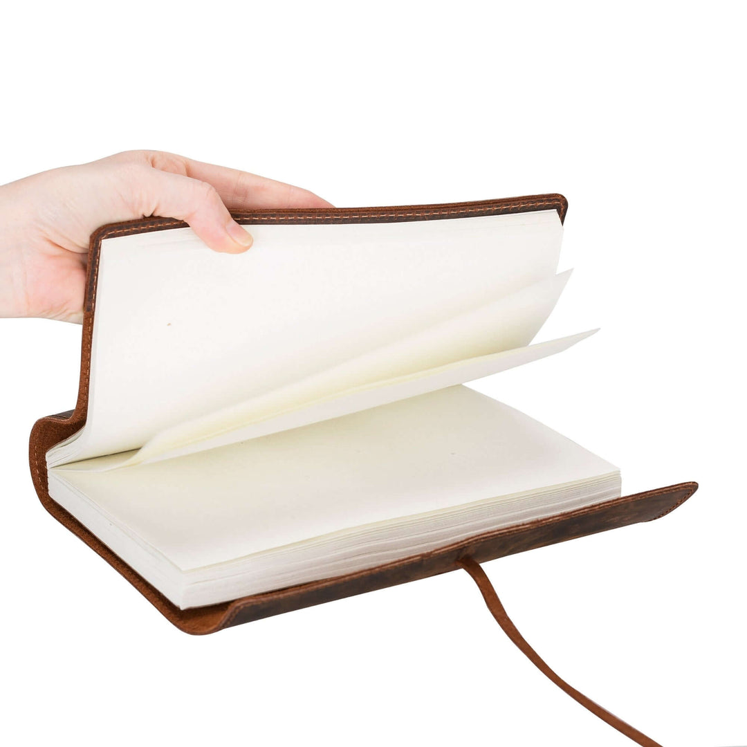 Hand holding Broomfield Handcrafted Leather Journal Cover open, showcasing its rich, genuine leather and sleek design.