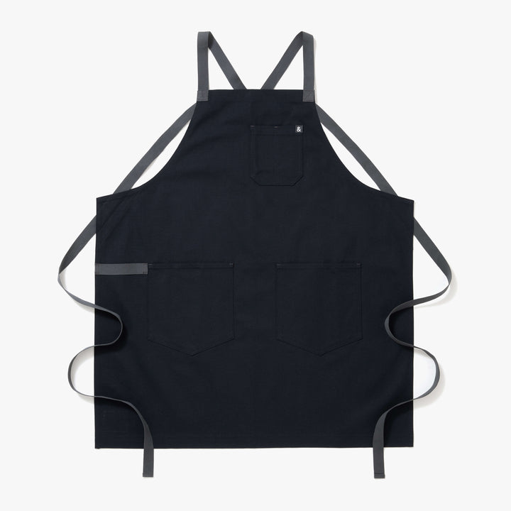 Midnight blue crossback apron with comfortable straps and functional pockets for all-day kitchen use