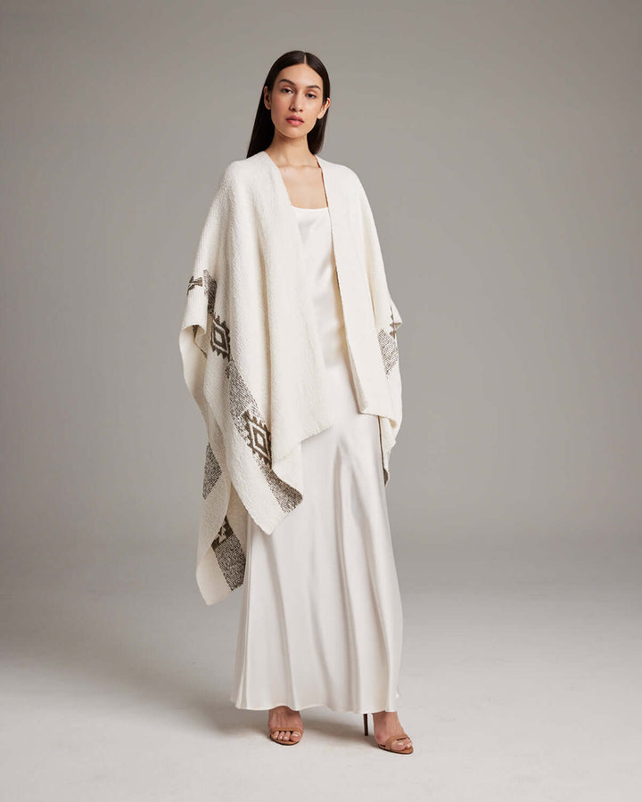 Model wearing Long Estrella Textured Cotton Duster, hand-loomed with Estrella symbol, crafted from organic Pima cotton by Mapuche artisans.