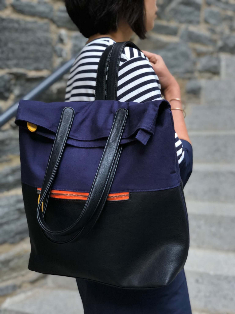 Convertible backpack tote bag made with organic cotton and vegan leather in natural earth tones with wood trim details