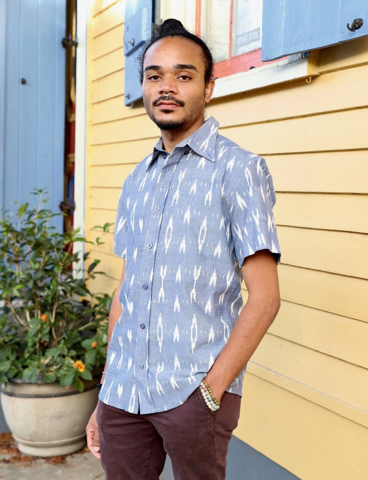 Light blue geometric print cotton button down shirt with short sleeves laid flat showing artisan handwoven texture