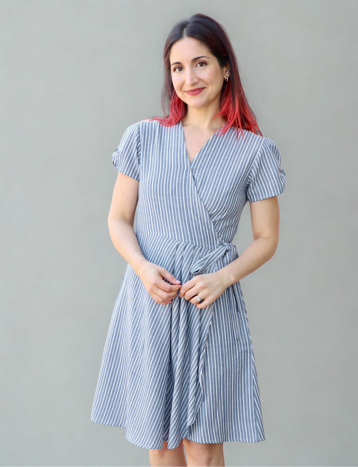 Organic cotton chambray wrap dress with pinstripe pattern and side pockets on model