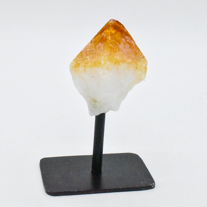 Natural crystal point mounted on black metal stand displaying amethyst citrine or clear quartz stone