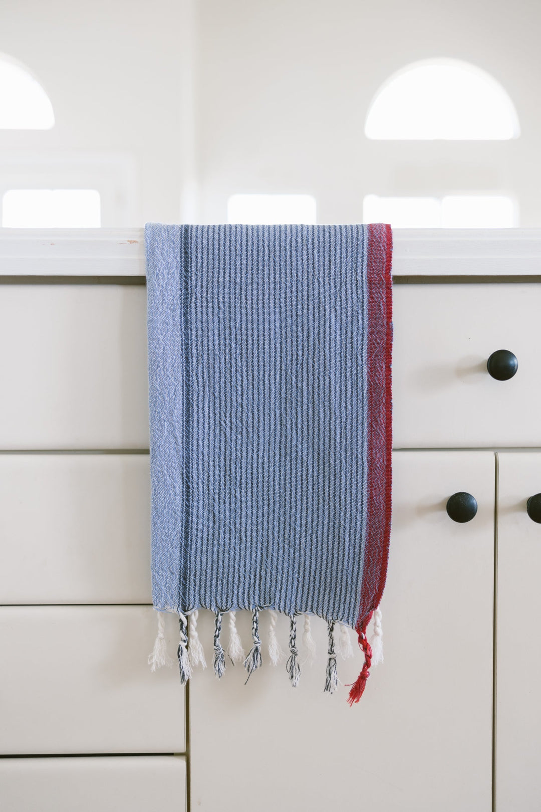Handwoven Turkish cotton hand towel in denim wash color displayed on natural surface