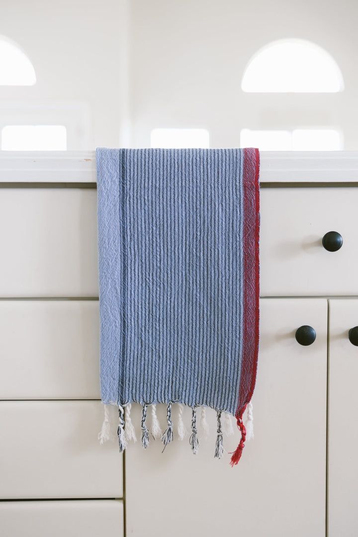 Handwoven Turkish cotton hand towel in denim wash color displayed on natural surface
