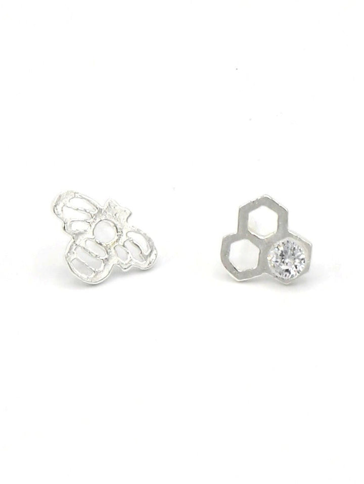 Handmade silver honeycomb and bee stud earrings with cubic zirconia details on white background