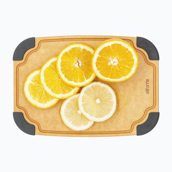 Small reversible cutting board with food icons and juice groove on sustainable pine leaf fiber material