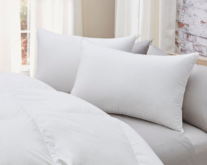 White goose down pillow with batiste cotton cover on neutral bedding