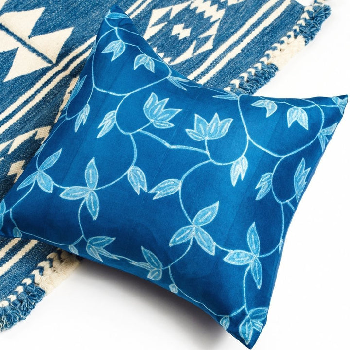 Handcrafted indigo shibori pillow with natural leaf patterns on mulberry silk in shades of blue