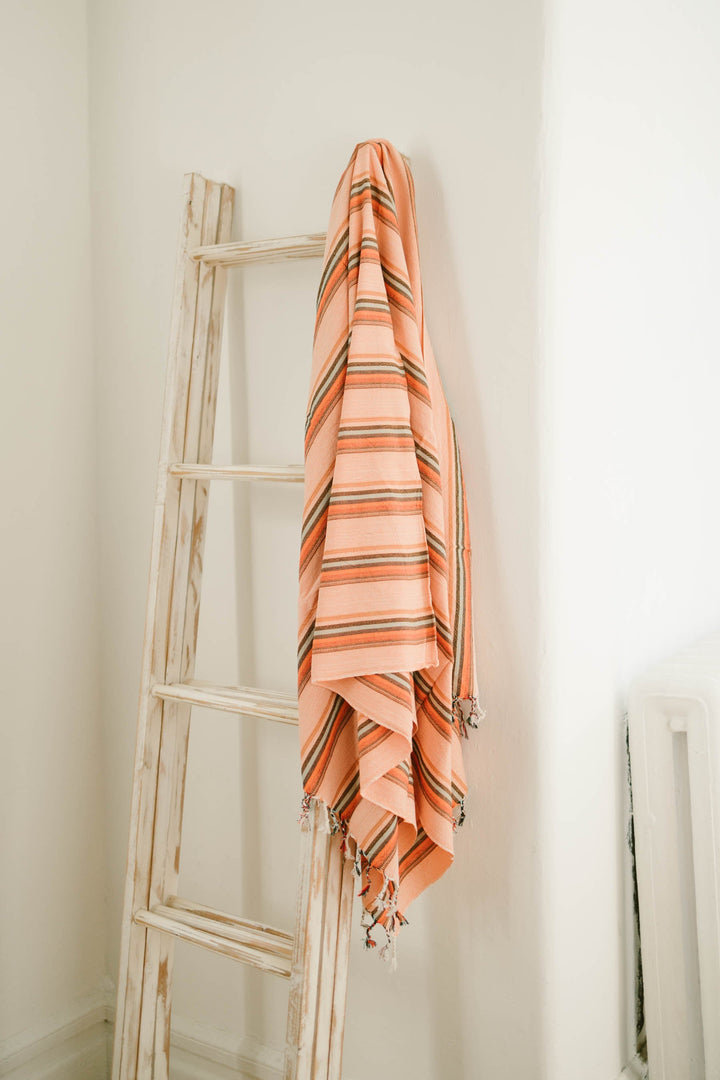 Handwoven Turkish pestemal towel in flame hudson color with traditional tassels made from ethically sourced cotton