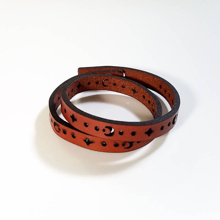 Leather double wrap bracelet with sun and moon laser cut design, in Auburn leather with adjustable button closure.