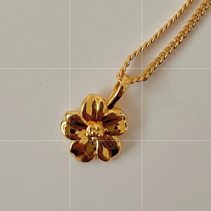 Gold hibiscus flower pendant necklace with 18-inch chain, hypoallergenic, nickel and lead free, handmade in Canada.