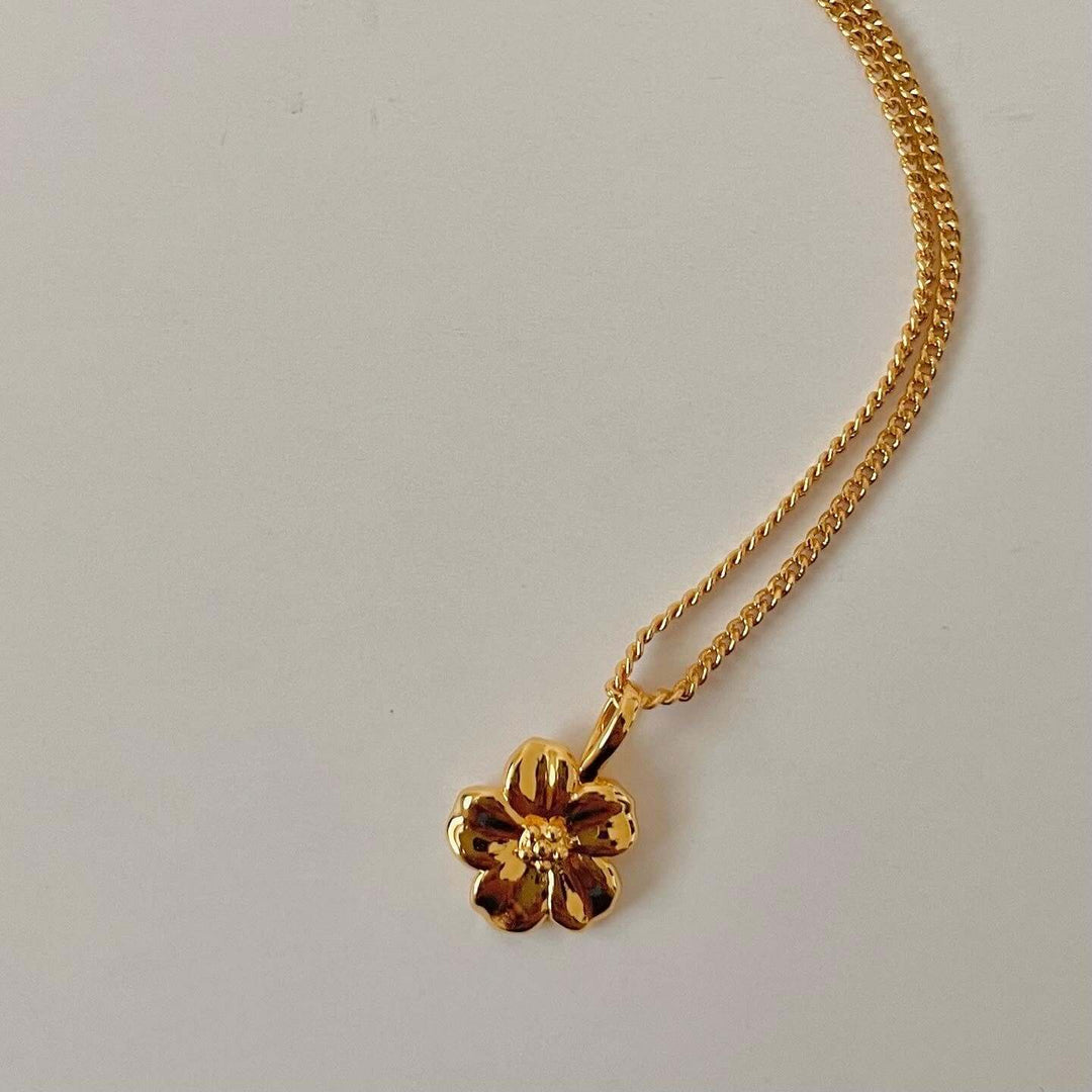 Gold hibiscus pendant necklace with 18-inch chain and lobster clasp, hypoallergenic, nickel and lead-free, handmade in Canada.