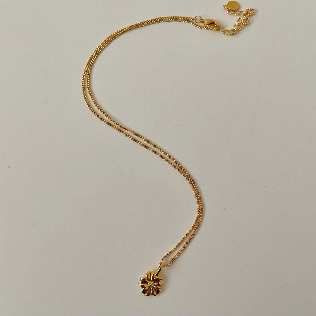 Gold hibiscus pendant necklace with 18-inch chain, hypoallergenic, nickel and lead free, handmade in Canada.