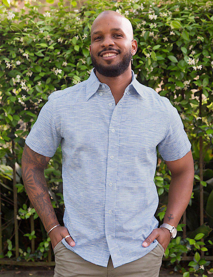 Light blue handwoven cotton short sleeve button down shirt with slim fit tailoring on model
