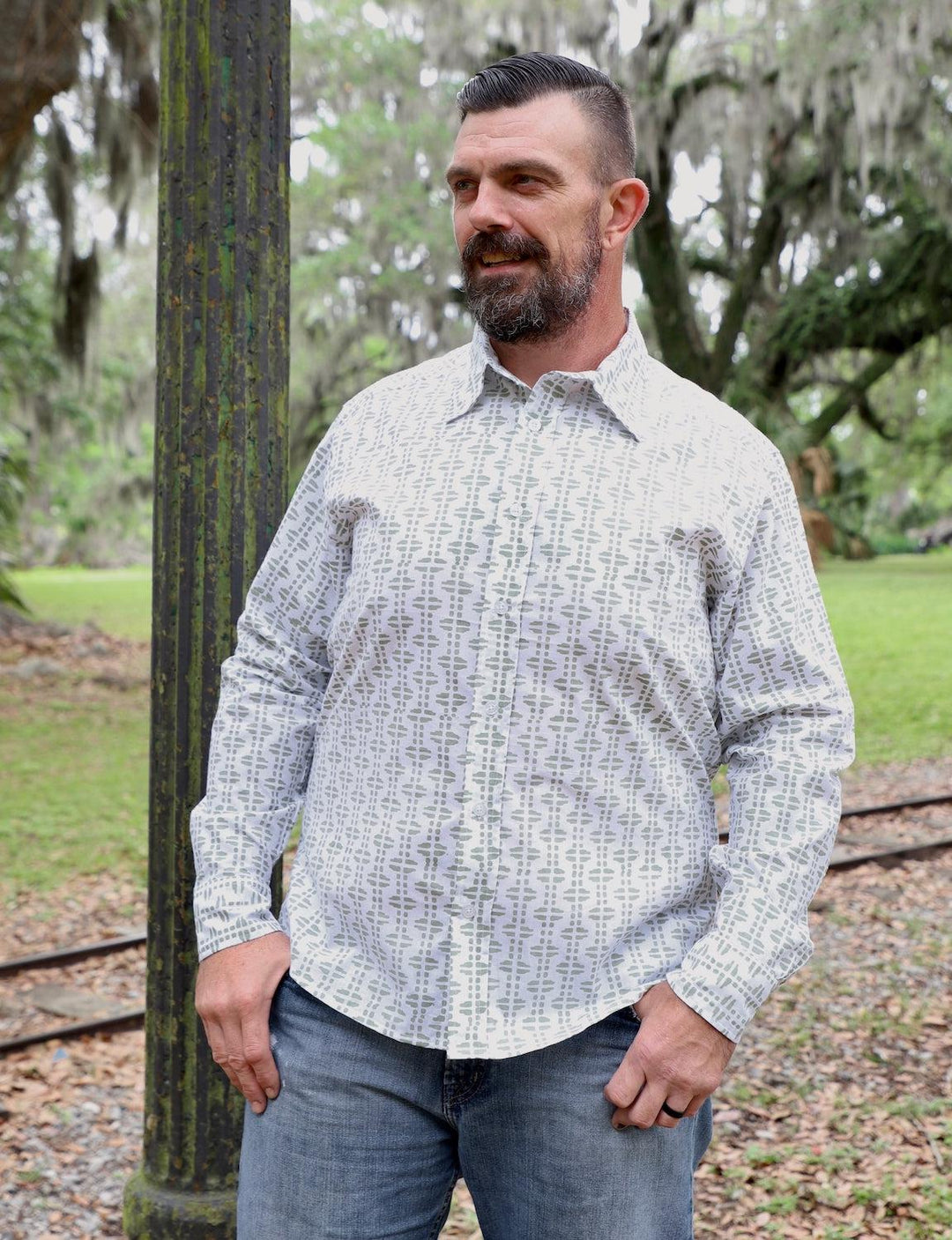 Pistachio green organic cotton men's button down shirt with white details on neutral background