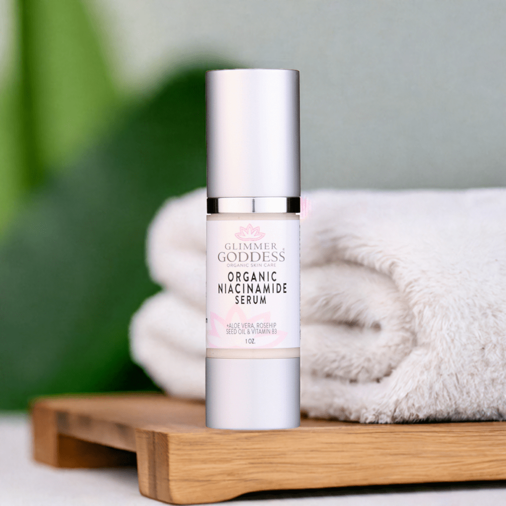 Bottle of Organic Niacinamide Anti Aging Serum on wooden tray with towels