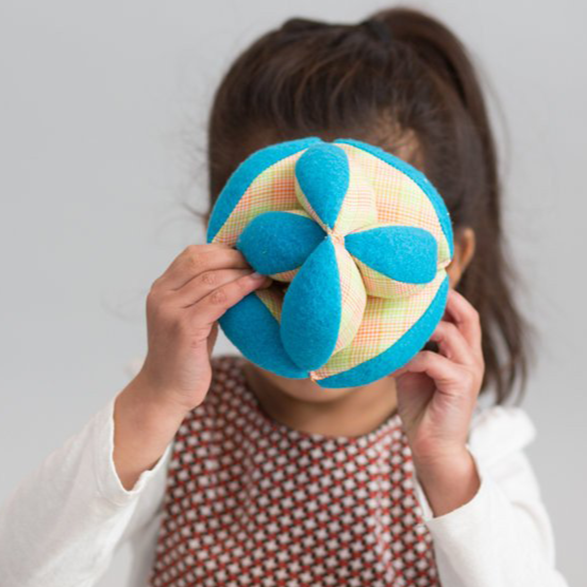 Handcrafted plush puzzle ball with three soft fabric pieces in natural colors for toddler learning and play