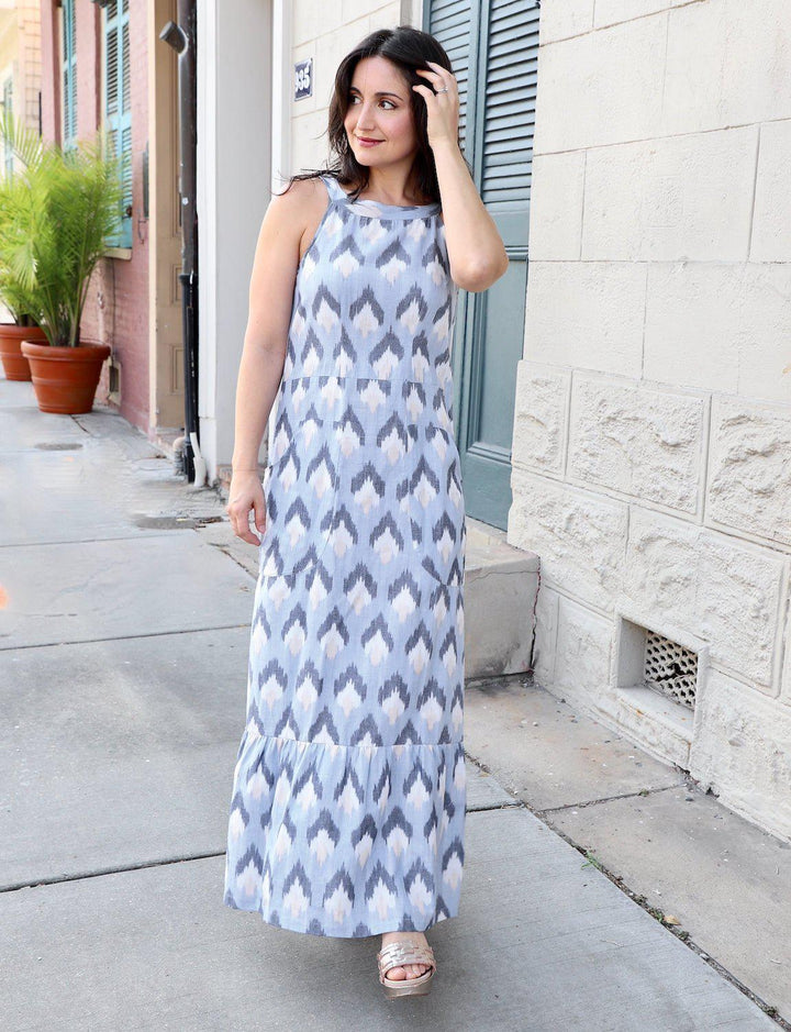 Blue and white ikat organic cotton tiered maxi dress with front pockets on model