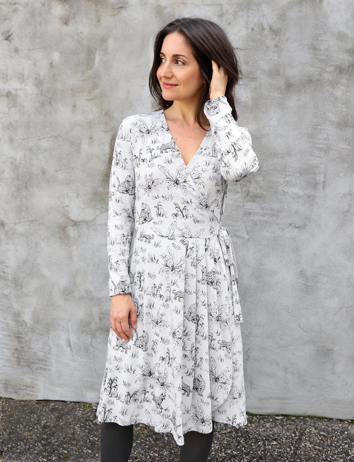 Grey organic cotton wrap dress with hand screen printed jungle design and long sleeves on model
