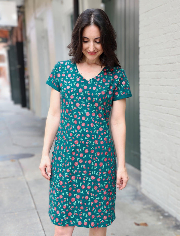 Emerald green organic cotton dress with hand screen printed red rose pattern and flattering v-neckline